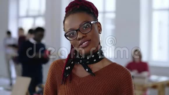 年轻快乐的非洲创意设计师职业成功的商业女性戴着眼镜兴高采烈地在办公室微笑视频的预览图