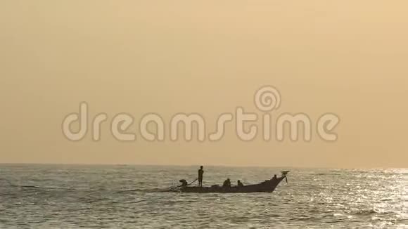 夕阳西下一艘水手带着人钓鱼的帆船是一艘帆船的剪影海面上一片白热烈的太阳视频的预览图