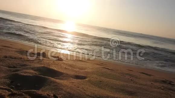 海滩上五彩缤纷的金色日落落日余晖映在大海和沙滩上五颜六色的海滩日出与阳光视频的预览图