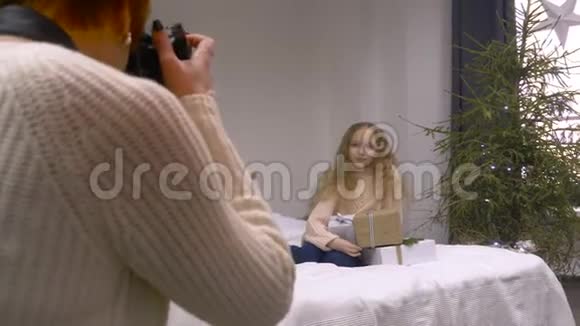 摄影师用礼品盒拍摄一个女孩视频的预览图