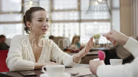 年轻女子把结婚戒指戴在手指上成年男子在餐馆里亲吻她的手视频的预览图