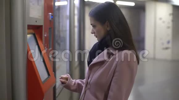 年轻女性游客在自助服务终端购买门票付款视频的预览图