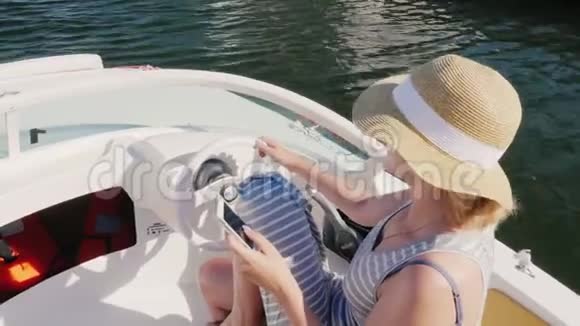 女人的帽子漂浮在船上用手机从上面看概念西班牙和欧洲的海上假日视频的预览图