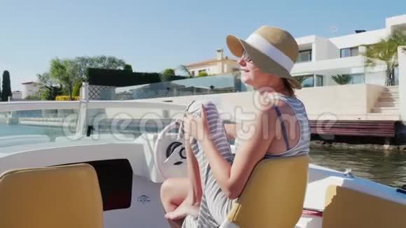年轻女子在欧洲度假胜地度假在西班牙埃姆普里布拉瓦海峡的船上漂浮视频的预览图