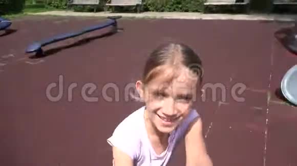 在游乐场奔跑的童童旋转在公园4K欢笑的微笑女孩画像视频的预览图