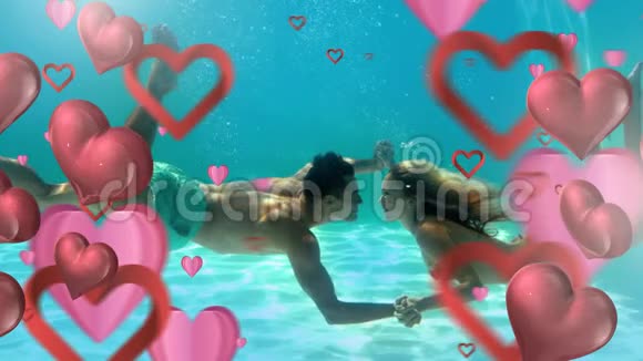 情人节快乐的一对情侣在水下与心亲吻视频的预览图