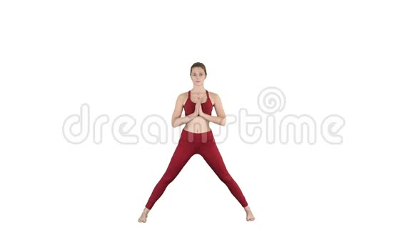 年轻女子在前弯体式瑜伽姿势的白色背景视频的预览图