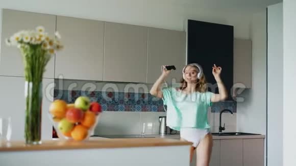 穿T恤的女孩在厨房唱歌跳舞穿内衣的快乐女人视频的预览图