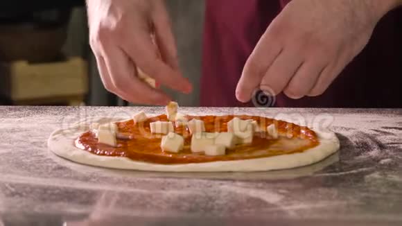 厨师把奶酪块放进披萨里视频的预览图
