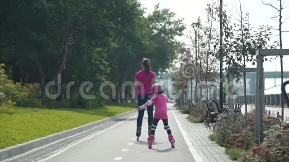 年轻的女人和女儿一起滑旱冰视频的预览图