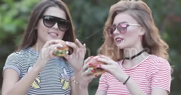 两个漂亮时髦的女孩吃汉堡包视频的预览图