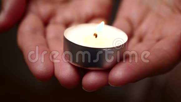 手里拿着蜡烛女性手中蜡烛照明背景仁慈的背景悲伤的概念视频的预览图