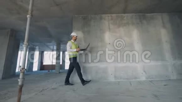 男建筑检查员正快步穿过建筑工地视频的预览图