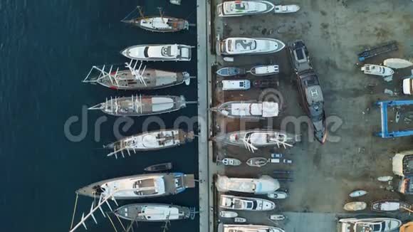 游艇和船只停泊在码头船厂从上面可以看到空中景色视频的预览图