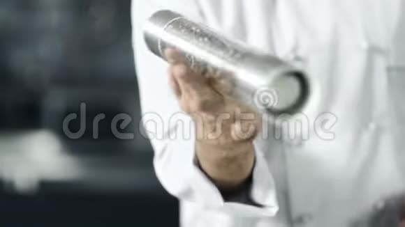 男厨师在厨房用胡椒盒做饭特写男手玩胡椒盒视频的预览图