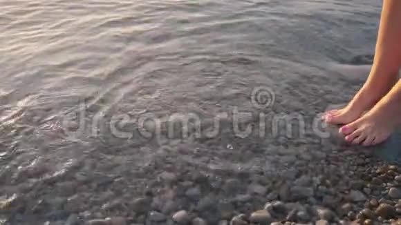 日出时女性赤脚站在岸上视频的预览图