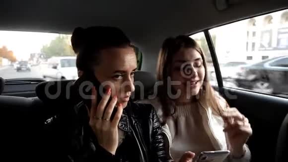 两个女孩坐出租车去一个打电话另一个听音乐唱歌视频的预览图