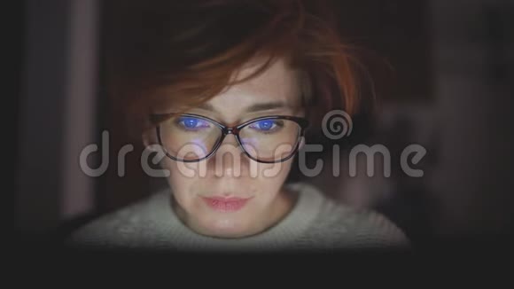 集中精力的女商人戴着眼镜深夜在办公室里用电脑工作视频的预览图