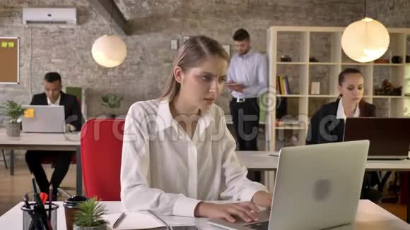 年轻漂亮的商界女性很高兴因为在办公室里发现了好消息人们正在与科技建立联系视频的预览图