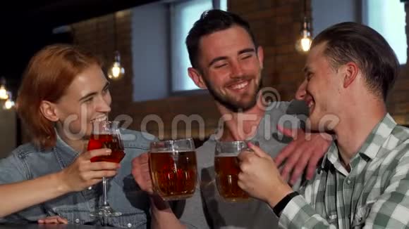 快乐的年轻人喝着啤酒对着镜头微笑视频的预览图