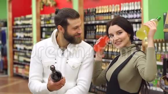 在超市里一对漂亮的选择酒精饮料时笑了视频的预览图