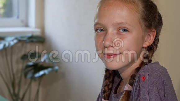 可爱的红发女孩带着雀斑微笑着在学校画画视频的预览图