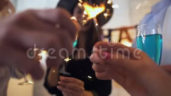 在万圣节派对上年轻人微笑着拿着孟加拉灯和鸡尾酒视频的预览图