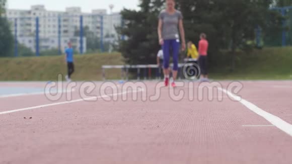 年轻漂亮的女运动员在城市体育场馆进行快速跑步训练在慢速训练中进行一天的训练视频的预览图