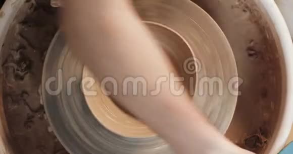 陶工在扭曲的陶轮上制作陶瓷锅上景波特在工作关门手工制作工艺白色粘土视频的预览图