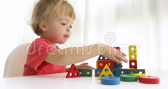 小男孩玩色块捣毁了一栋盖好的房子视频的预览图