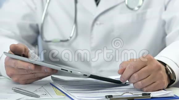 男性医生在平板电脑上打字插入数据医疗改革视频的预览图