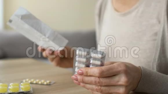老年妇女在桌上读药片说明书有害的自我治疗视频的预览图