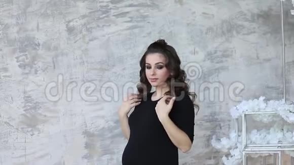 孕妇站在灰墙前工作室模型视频的预览图