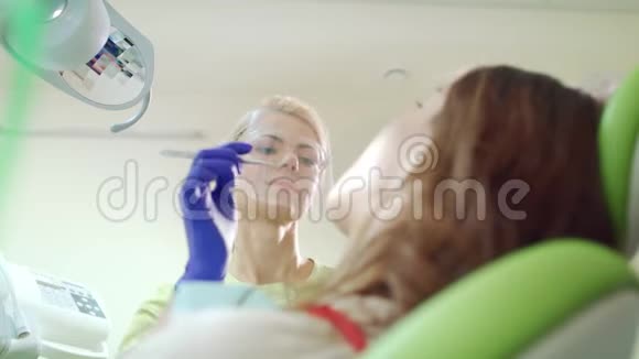 微笑牙医在牙科办公室和病人一起工作口腔专业视频的预览图