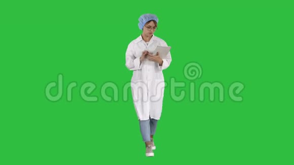 女医生使用平板电脑和行走在绿色屏幕色度键视频的预览图