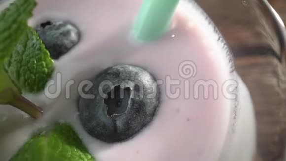 蓝莓草莓和牛奶酸奶上面有浆果和薄荷视频的预览图