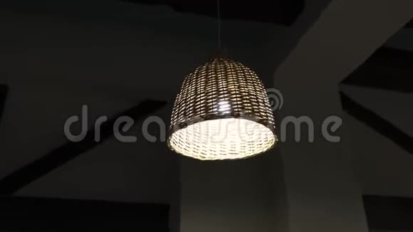 一家著名的餐馆几盏藤条吊灯装饰在一个漆黑的天花板上视频的预览图