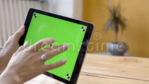 为在平板电脑上工作的漂亮年轻女性提供绿色屏幕特写库存录像女性双手抓住并抓住视频的预览图