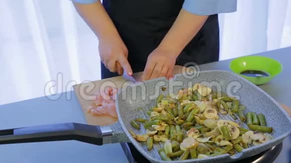 女人切鸡柳做泰国面条和蔬菜视频的预览图