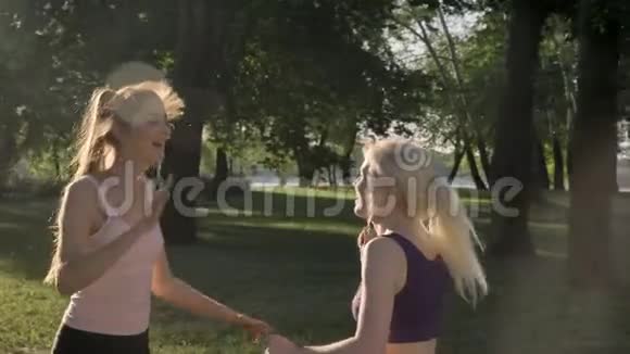 两个年轻漂亮的女人在公园里参加他们的晨间工作给了高五微笑快乐健康视频的预览图