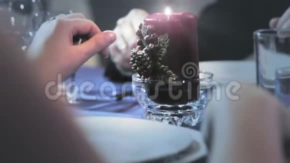 女人触摸桌子上的蜡烛视频的预览图