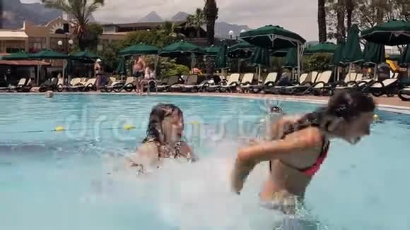 快乐的少女们在游泳池里游泳和潜水视频的预览图