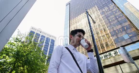 男子在街头打电话时喝咖啡视频的预览图