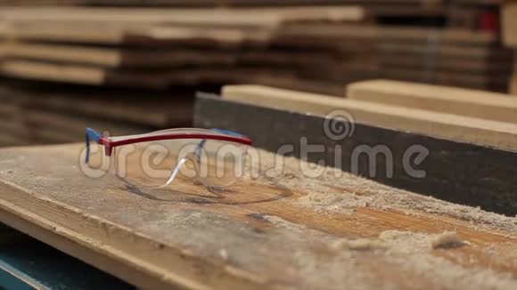 建筑眼镜护目镜到处都是木屑锯木厂伐木概念慢动作视频的预览图