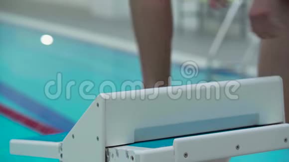 专业运动的男性游泳运动员从室内游泳池的起点跳入游泳池关门视频的预览图