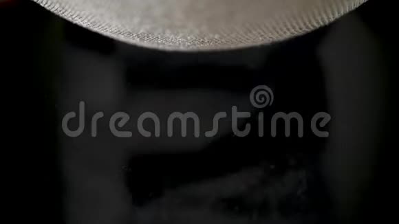 面粉通过黑色背景的筛子筛过视频的预览图