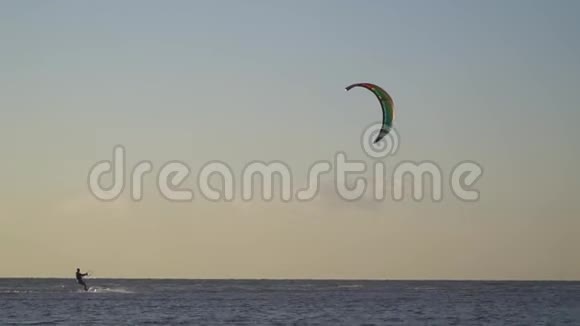 一个人在刮风的下午在海上放风筝鸟儿飞过天空视频的预览图