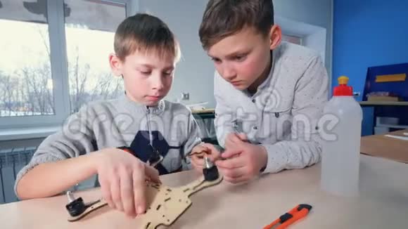两个男孩的年轻工程师做无人机模型4K视频的预览图