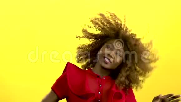 非裔美国女孩跳着跳着玩音乐黄色背景慢动作视频的预览图