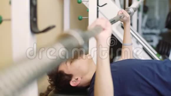 一个有听力障碍的15岁男孩在健身房训练助听器里的人在健身房坐凳视频的预览图
